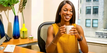 Hvad er god ledelse - tilfreds kvinde bag sit skrivebord