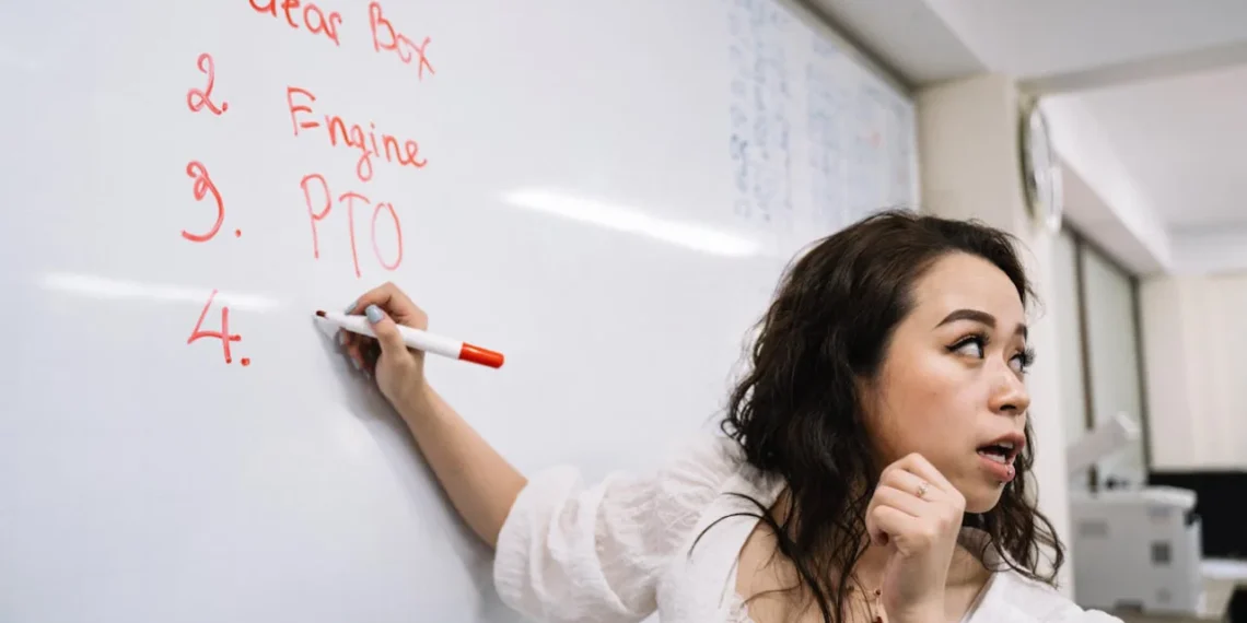 Kvinde står ved tavle og arbejder med kompleksitetsteori