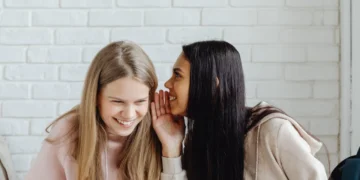 Socialkonstruktionisme 2 kvinder hvisker til hinanden