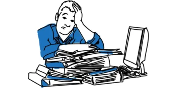 Ensomhed - tegnet mand i blå sidder ensom ved skrivebord