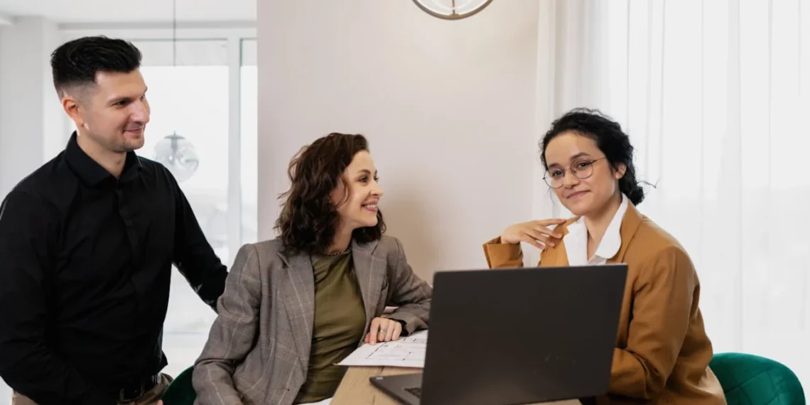 3 mennesker rundt om en pc som systemisk coaching
