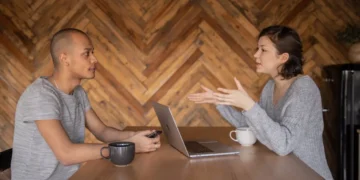 Mand sidder overfor kvindelig interviewer til jobsamtale.