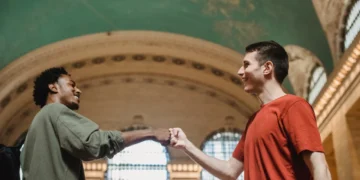 To mænd giver hinanden ros med knoer mod hinanden i italiensk katedral.